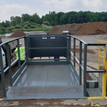 support_1628092318_New Wastequip rear feed 2-yard stationary at a dock